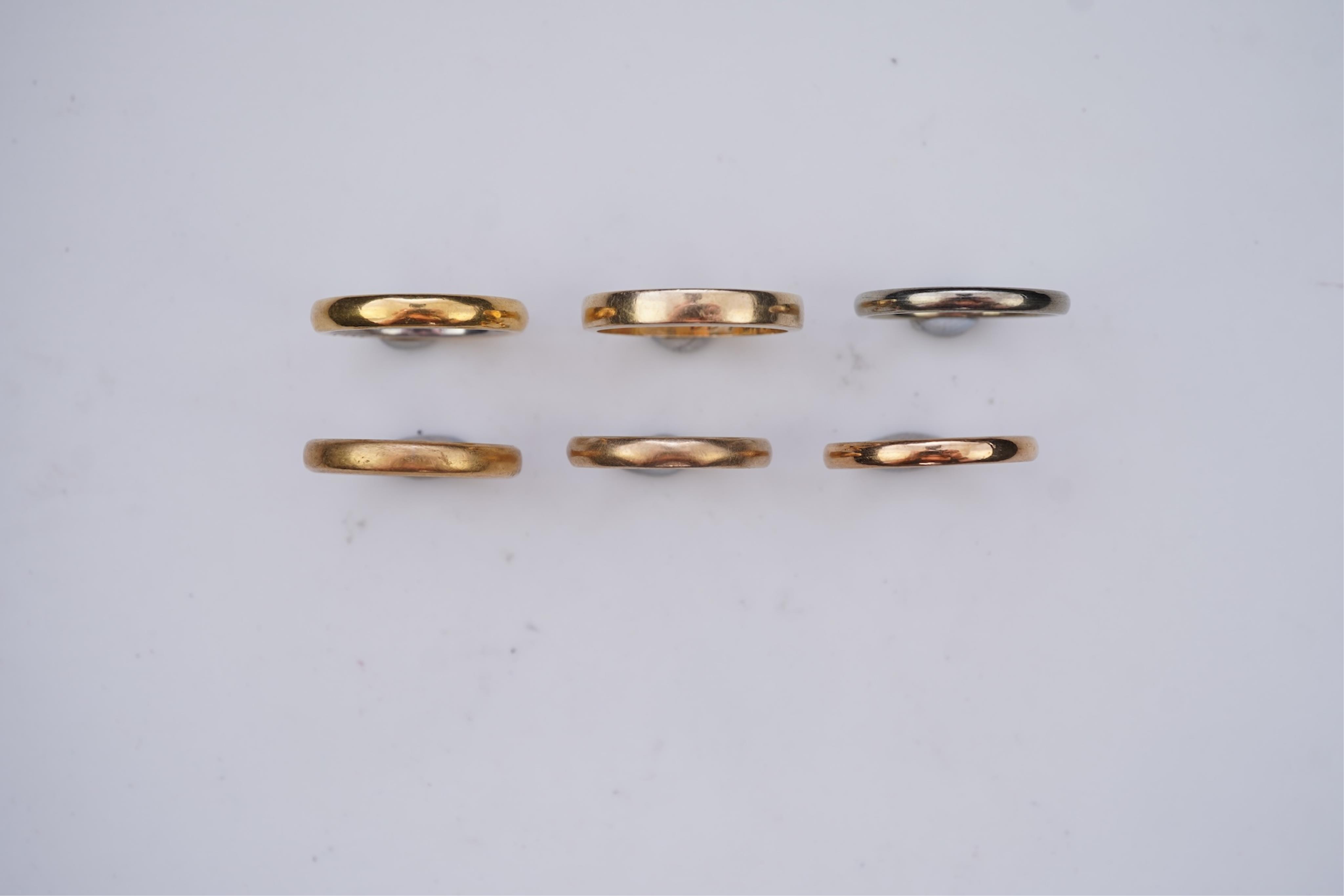 A collection of six gold wedding bands